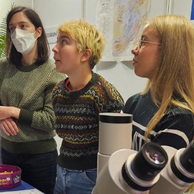 Geography and Geoscience Stand - Microscope, Lecturer and 2 students